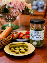 Load image into Gallery viewer, table photo of a plate with sliced persian pickled cucumbers, a closed jar of Persian pickled cucumbers, a basked of bread and a small bowl with sliced tomatoes and bread