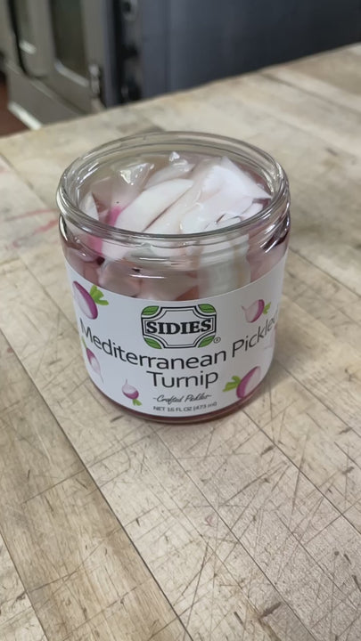 Video of red beet juice being poured into jar of Mediterranean pickled turnip