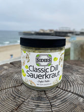 Load image into Gallery viewer, jar of classic dill sauerkraut with a beach background
