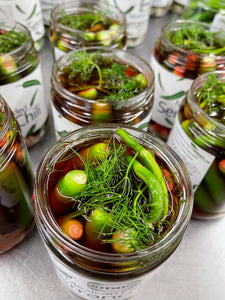 overhead view of open jars of Mexican pickled serrano chilies