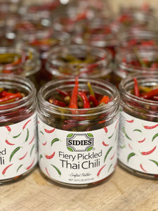 several open jars of pickled thai chili