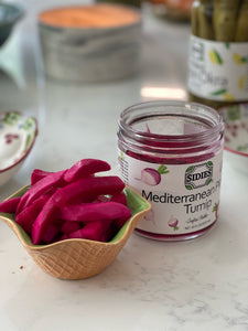 Small bowl of pickled turnip next to an open jar of Mediterranean pickled turnip